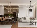 Nowoczesny bungalow z jadalnią i salonem. Lustrzana ściana odbija wiszące lampy, a wygodna sofa zaprasza do relaksu.