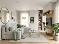 Jasny, przytulny, bardzo mały salon w bloku. Szara kanapa, okrągłe stoliki, regały i telewizor.